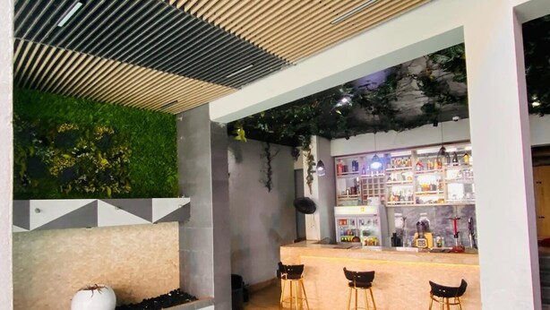 A modern indoor pool area with a bar and seating. - 2020 Apartment Guzape (Abuja)