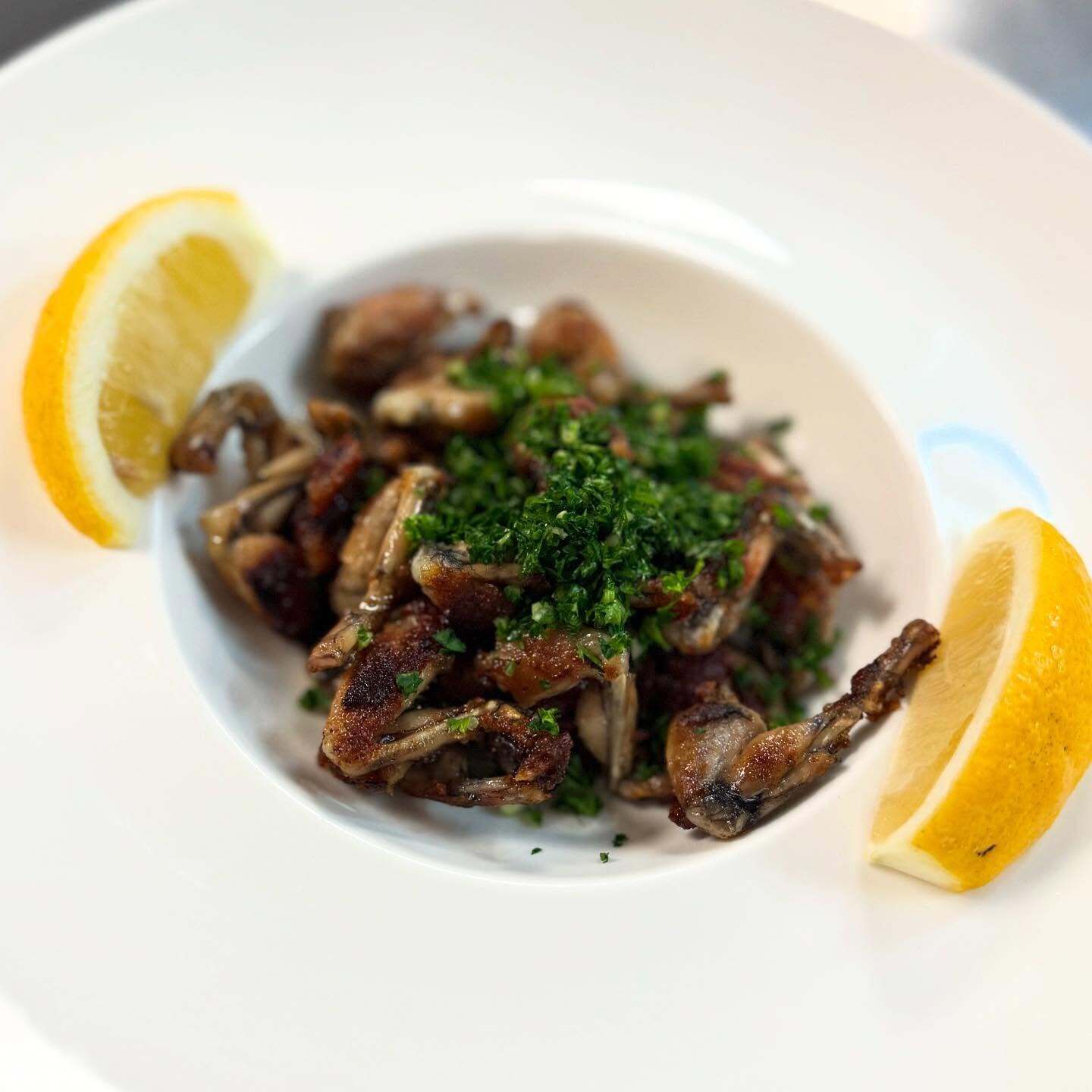 A plate of food with lemon slices and parsley garnish.