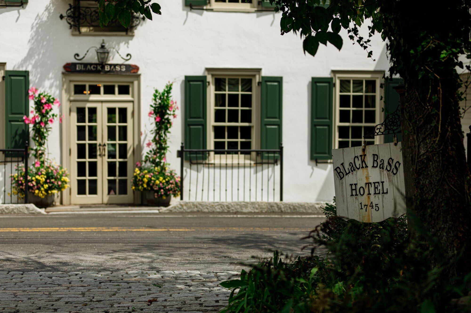 A building with a sign reading "Black Bass Hotel 1745".