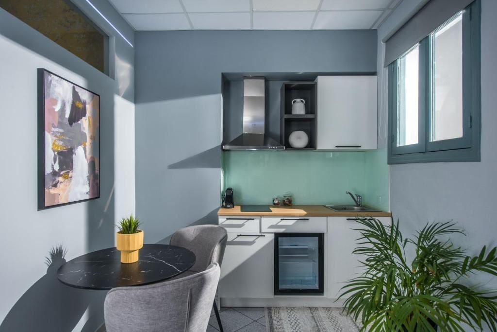 A compact kitchen with a built-in oven, a small sink, and a window.