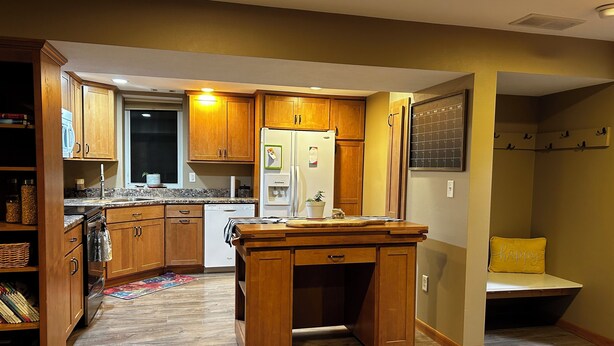 A kitchen with wooden cabinets, a built-in oven, and a refrigerator. - Spacious 4-bedroom house in perfect Marshall for your getaway (Marshall)