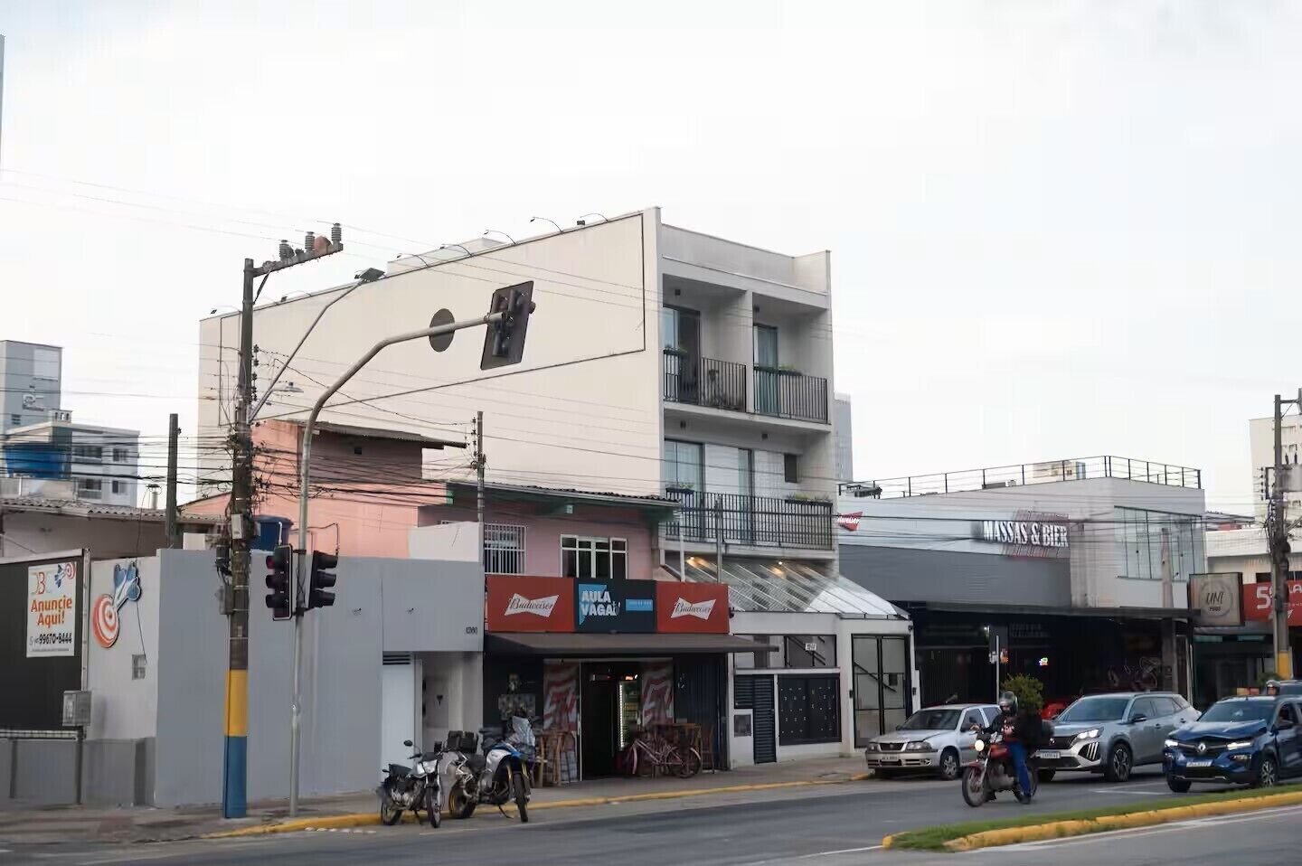 A multi-story building with a commercial ground floor featuring a bar and a restaurant.