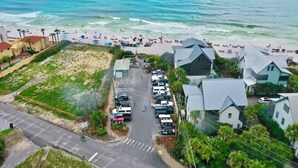 An aerial view of a coastal area with a beach, parked cars, and buildings with unique architecture. - Blue Mountain Home, Pet friendly, Pool, 4 Bikes, Beach (Santa Rosa Beach)