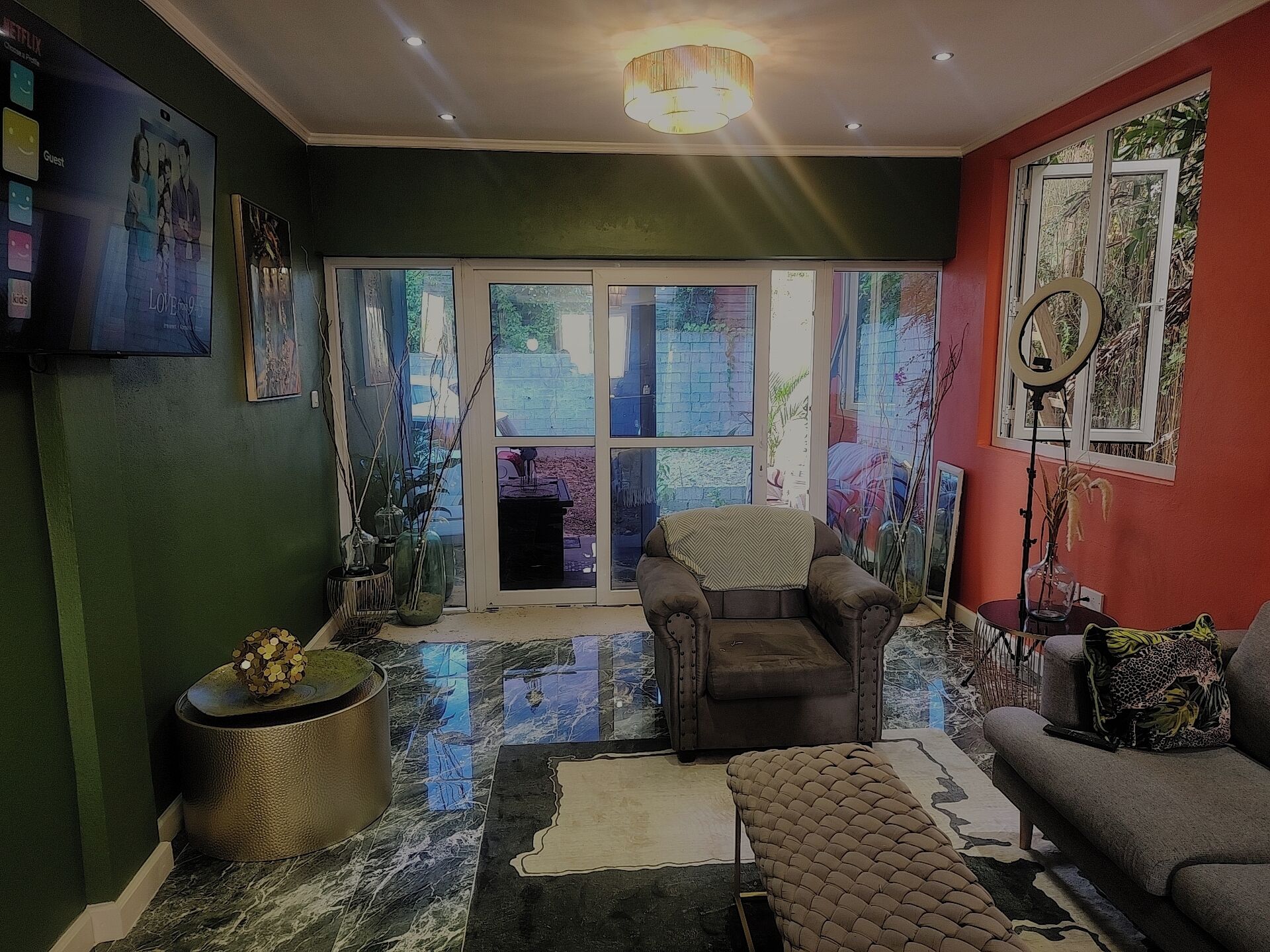 Un salon comprenant un canapé, un fauteuil et une petite table agrémentée d’objets décoratifs.