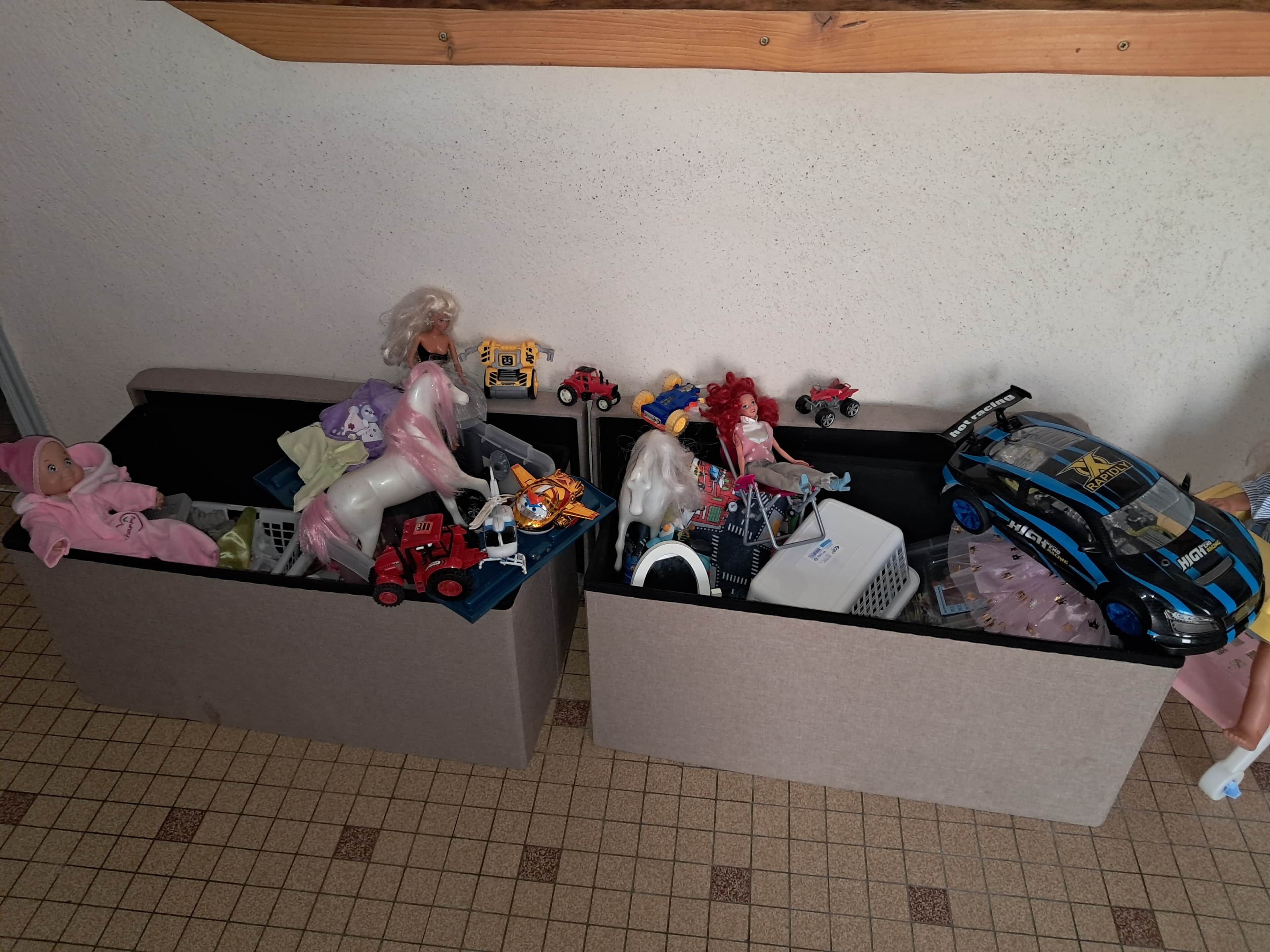 Two storage bins filled with toys and dolls.