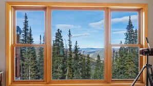 A large window with a view of a forested mountain landscape. - The Summit at 11 • 15 Min to Breck • Private Hot Tub Views •  Sauna •... (Breckenridge)