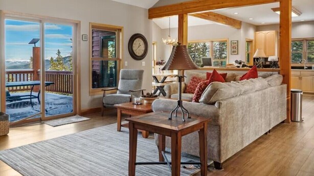 A spacious living room with a sofa, a coffee table, and a dining area. - The Summit at 11 • 15 Min to Breck • Private Hot Tub Views •  Sauna •... (Breckenridge)