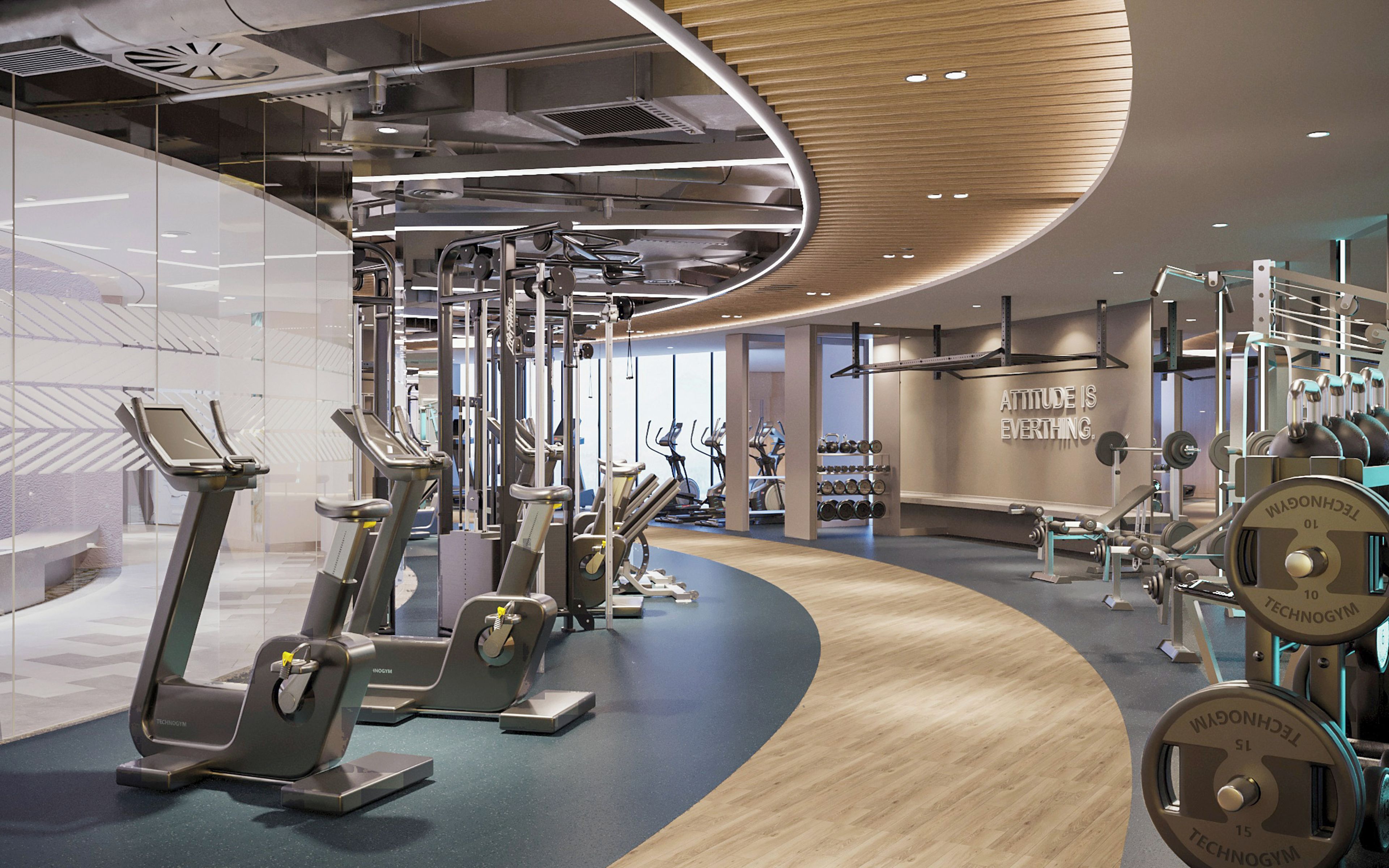 Un gimnasio moderno con máquinas de cardio, pesas libres y una frase motivacional en la pared.