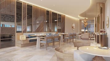 Un moderno vestíbulo de hotel con una zona de estar, un mostrador de recepción y una escalera.