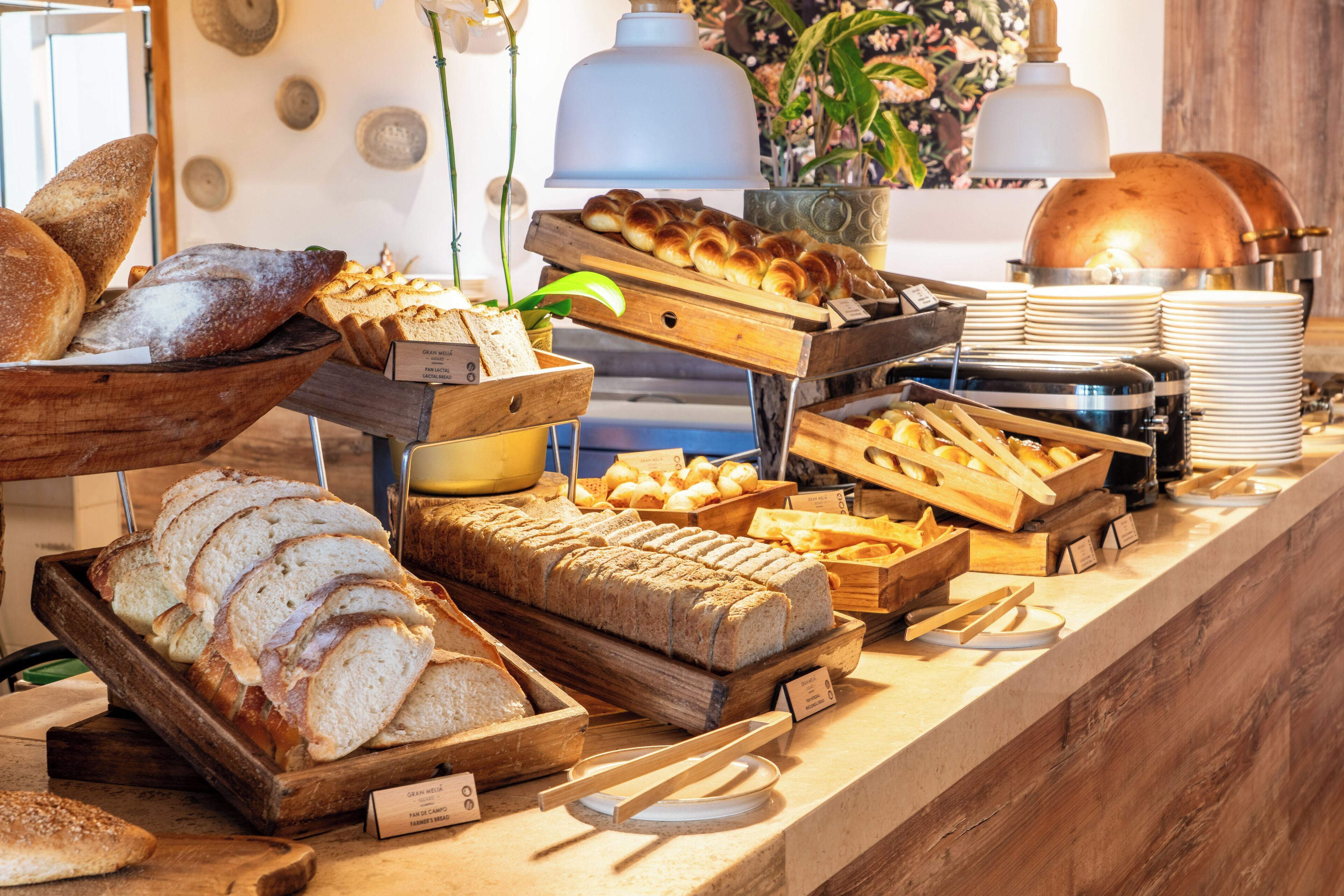 A bakery display with various breads and pastries.
