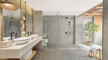 A modern bathroom with a glass shower enclosure, a large mirror, and a wooden ceiling.