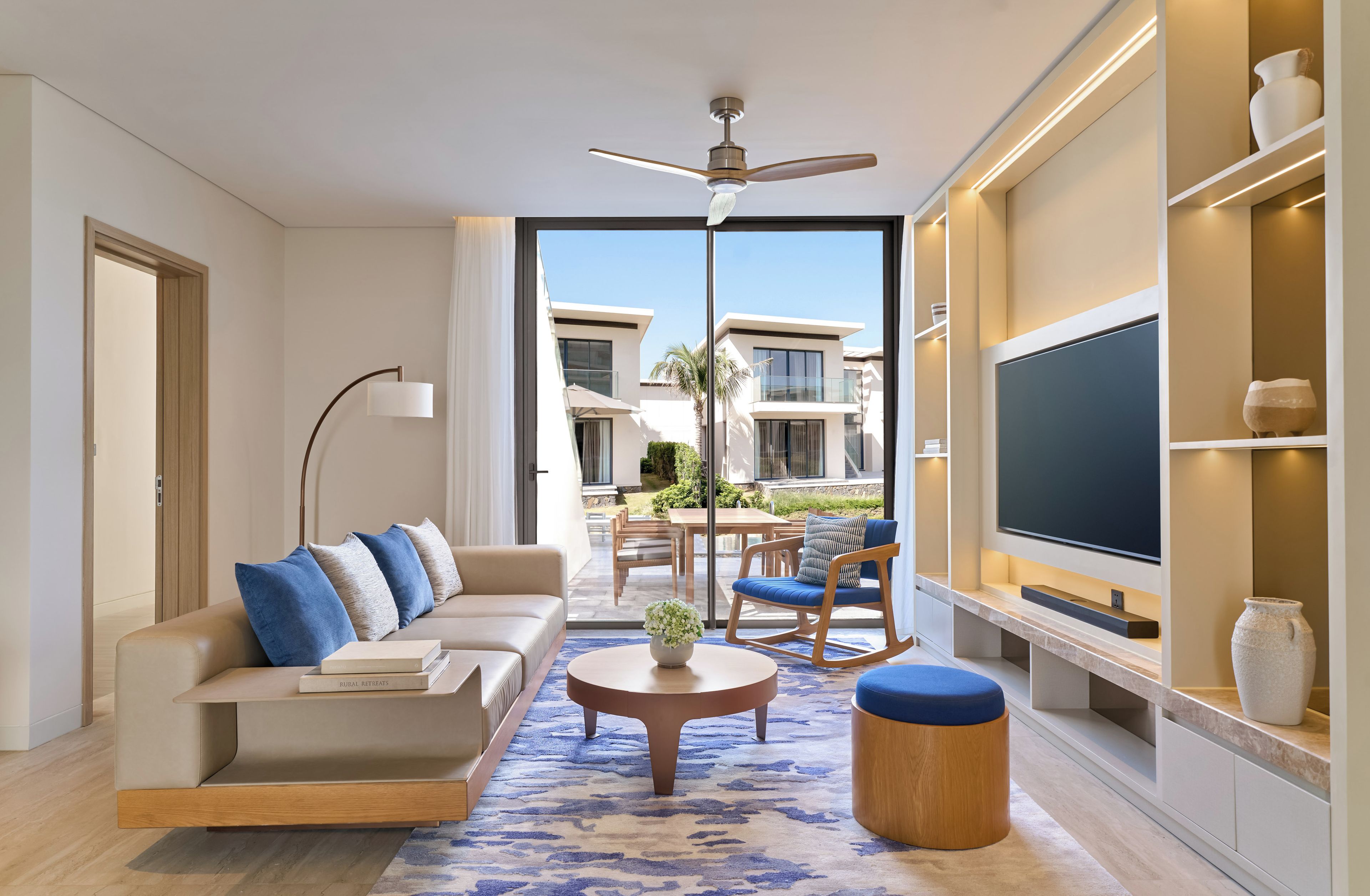 A modern living room with a sofa, coffee table, and TV.