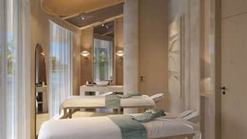 A modern bedroom with a large bed, a bedside table, a mirror, and a hanging light fixture.