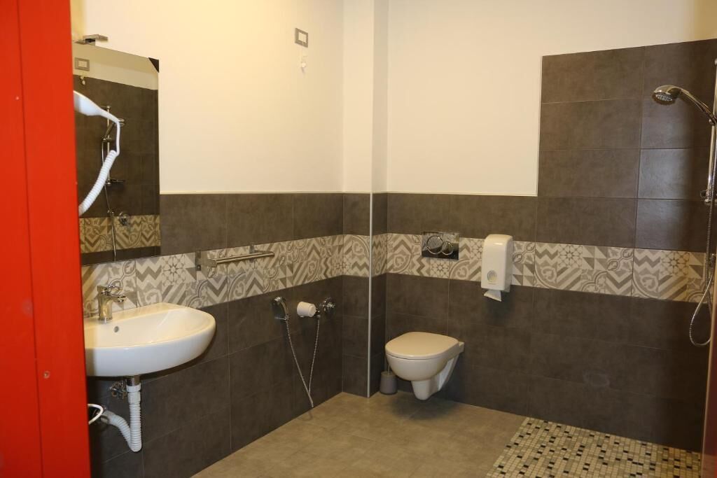 A bathroom with a sink, toilet, and shower.