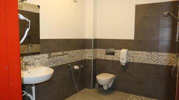 A bathroom with a sink, toilet, and shower.