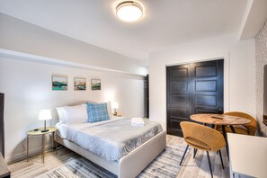 Escritorio, tabla de planchar con plancha, wifi y ropa de cama