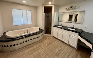 A bathroom with a freestanding bathtub, a shower, and a vanity with two sinks. - 3BD/3BA + Office Luxury Pool Pet Friendly with a backyard oasis (Phoenix)