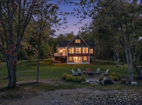 Stunning Lakefront Retreat set on a Private point on North Pond, 9 acres w/beach