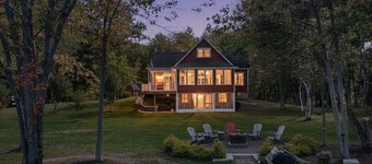 Stunning Lakefront Retreat set on a Private point on North Pond, 9 acres w/beach