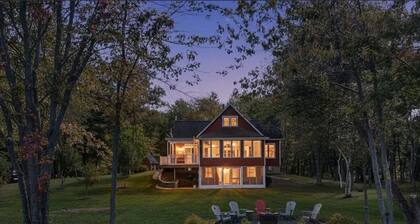 Stunning Lakefront Retreat set on a Private point on North Pond, 9 acres w/beach