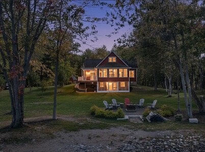 Stunning Lakefront Retreat set on a Private point on North Pond, 9 acres w/beach