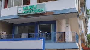 A multi-story building with a sign for 'Park Inn' and 'Mir V Infotecn'. - Park Inn (Port Blair)