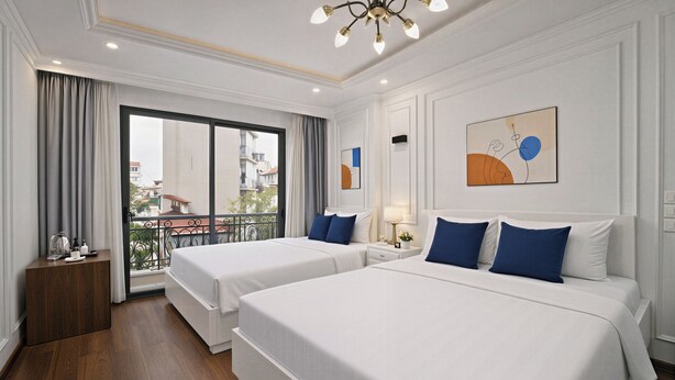 A hotel room with two beds, a balcony, and a large window. - Hanoi Miah 205 Hang Bong Hotel (Hanoi)
