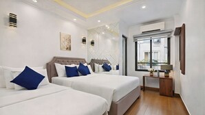 A hotel room with two beds, a small table, and a window with a view. - Hanoi Miah 205 Hang Bong Hotel (Hanoi)
