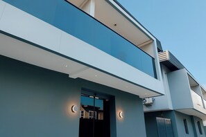 A modern two-story building with a flat roof, large windows, and a balcony. - Taja Hotels Ltd Adeniyi Jones Ikeja (Lagos)