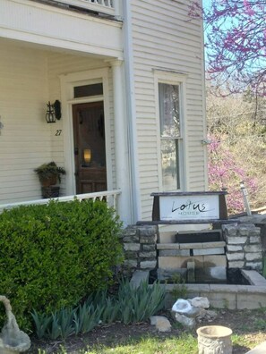 A house with a sign reading "Lotus House" in front. - The Bamboo Suite (Eureka Springs)