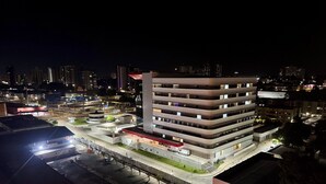 Un edifici de diverses plantes amb un disseny arquitectònic modern, que destaca per un pati central i nombrosos balcons.