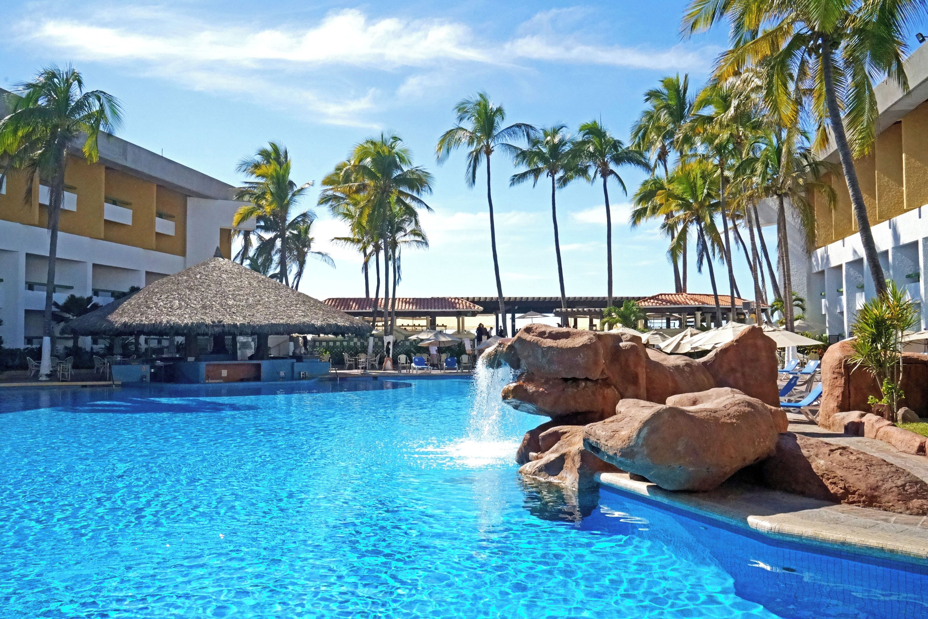 Outdoor pool, open 10:00 AM to 8:00 PM, pool umbrellas