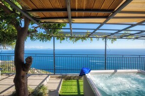 A pool area with a view of the ocean, a pergola, and a tree. - Casa Fortuna, Amalfi Coast (Campania)