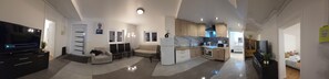 A modern apartment with a living room, dining area, kitchen, and a TV. - Poolside cottage (Oinville-sur-Montcient)