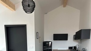 A modern kitchen with a black refrigerator, a microwave, and a stove. - Le Nid - Domaine de la Tour - New apartment for 6 people (Fleury)