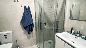 Een douche, een haardroger, een bidet, handdoeken