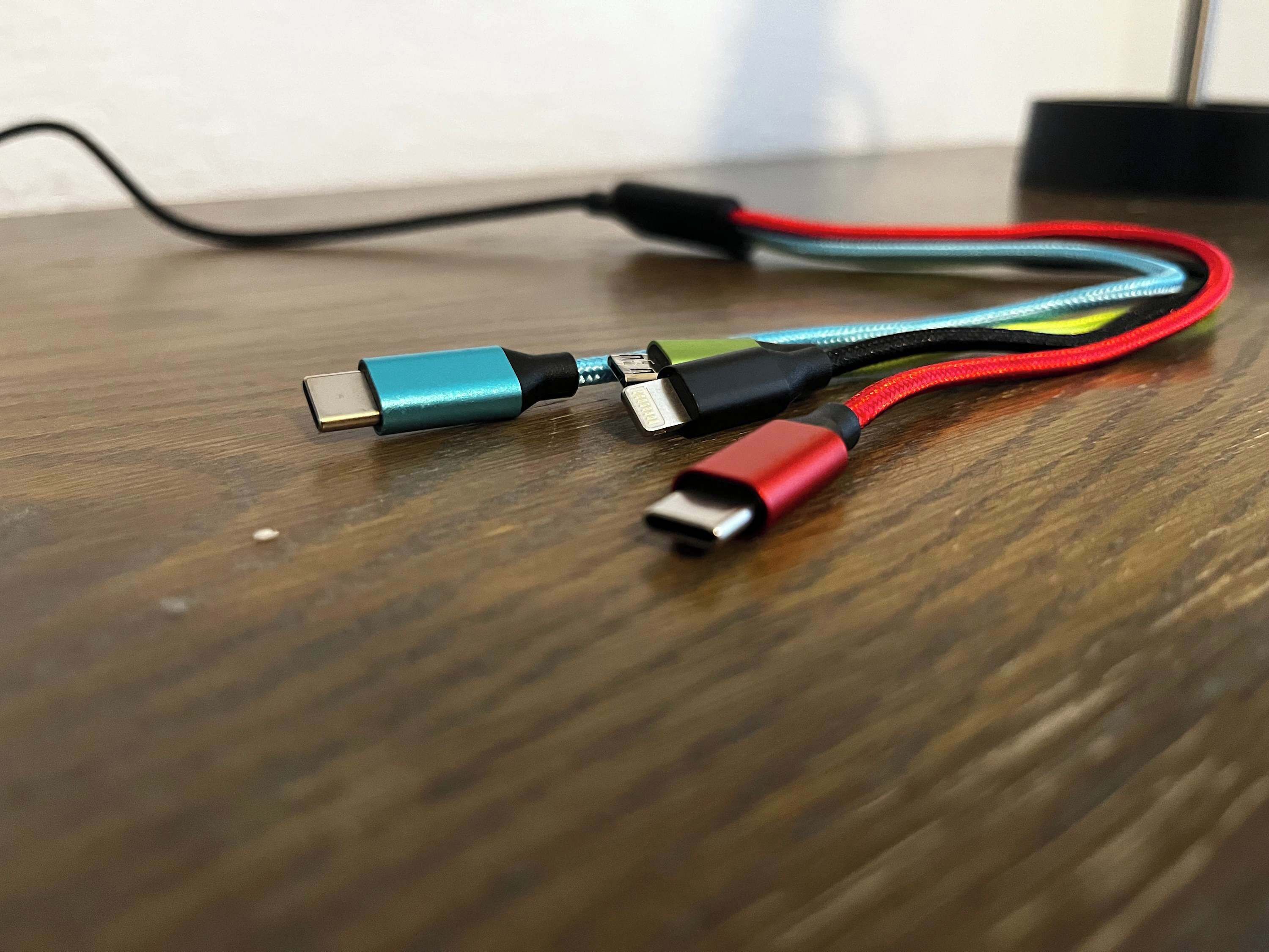 A USB cable with a USB-A connector and a USB-C connector on a wooden surface.