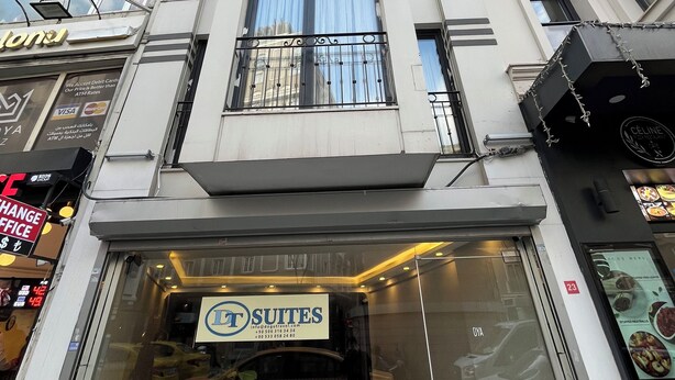 A modern building with a storefront labeled "Suites." - DT SUITES  (İstanbul)