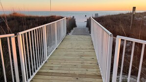 A wooden boardwalk leading to a beach with a clear view of the ocean. - Sugar Beach 2 Bedroom, 2 Bathroom Condo.  Heated Pool.  Free Daily Activities! (Orange Beach)