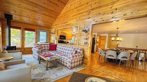 A cozy cabin interior with a living area, dining space, and kitchen. - Bouchard Shores Resort - Your Private Northwoods Getaway (Minocqua)