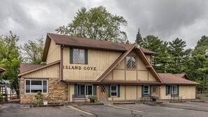 Il s’agit d’un bâtiment à deux étages, sur lequel on peut lire l’inscription « Island Cove ». Il se distingue par sa façade en pierre, ses nombreuses fenêtres dotées de volets verts et un parking situé à l’avant.