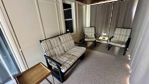 A room with a striped sofa, two armchairs, a small table, and a window with curtains. - Super Clean 2BR House: Quiet, Safe, Near Hwy, Big TV, Nightlife, Porch, by River (Beaver)