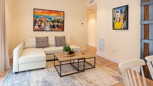A living room with a white sofa, a coffee table, and two paintings on the wall. - Coastal apartment in Málaga, near the beach, 2 bedrooms (Málaga)