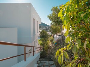 Un bâtiment blanc avec un escalier en pierre menant à un balcon.