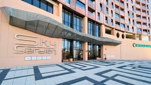 A hotel entrance with a modern design, featuring a large sign that reads "Sky Garden" and a visible entrance with glass doors. - Bright apartment with pool and gym in Malaga (Málaga)