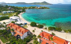 A coastal resort with beachfront villas, a sandy beach, and a view of the sea. - Sapphire Beach, Oceanfront, Pool, Steps to beach, Sleeps 4 (St. Thomas)