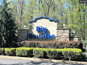 A sign for Big Boulder with a stone wall and trimmed hedges. - Mystic  Retreat | Hot Tub & Lake Harmony Access (Lake Harmony)