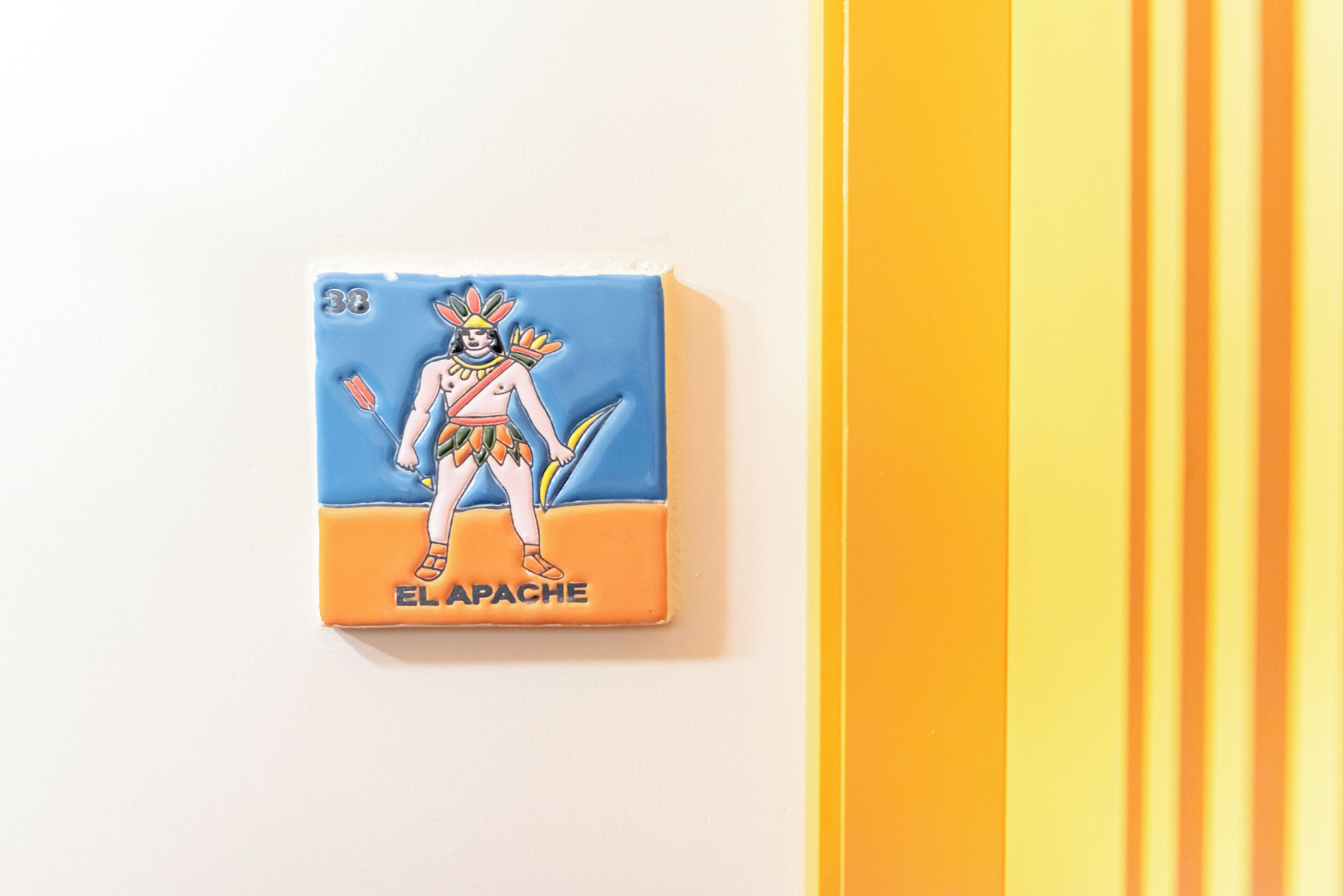 A card with a figure labeled "ELAPACHE" on a white background with vertical yellow stripes.