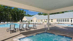 A hotel with a swimming pool area, including lounge chairs and a hot tub. - Seaglass Village 805: Coastal Charm Cottage - Spacious Port Model w/ Resort Amenities (Wells)