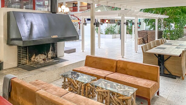 A patio area with a large grill, cushioned seating, and a glass-top table. - Amazing apartment in Bjorli with WiFi (Bjorli)